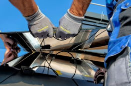 two-men-carrying-a-metal-sheet.jpg two men carrying a metal sheet