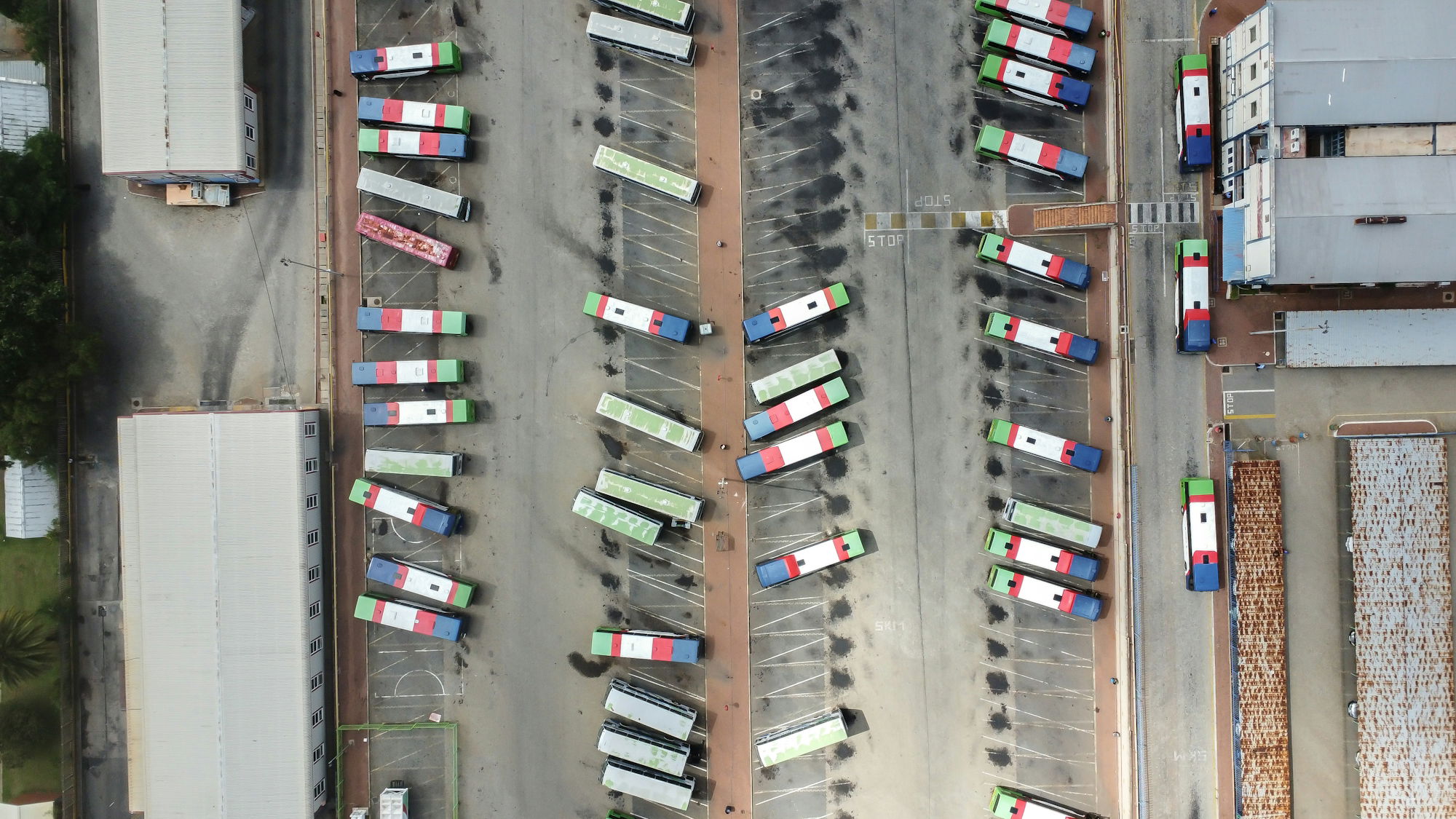 an-aerial-view-of-a-parking-lot-filled-with-cars.jpg an aerial view of a parking lot filled with cars
